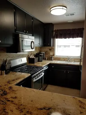 a kitchen with a stove and a microwave at Beautiful Mountain Home in Tehachapi