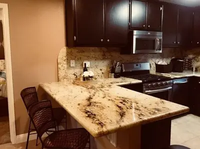a kitchen with a marble counter top and a stove at Beautiful Mountain Home in Tehachapi