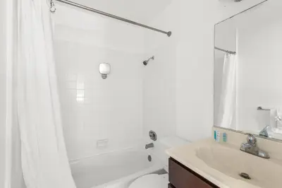 a white bathroom with a tub and a sink at Modern Furnished 2 Bedroom in West LA in Los Angeles