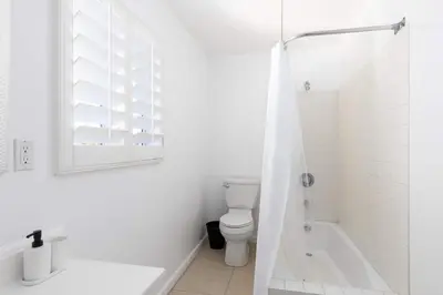 a white bathroom with a toilet and a shower at 3 bedroom near Culver City-Palms in Los Angeles