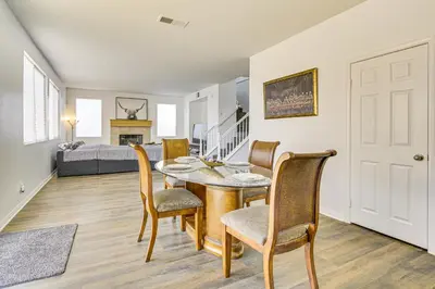 a dining room with a table and chairs and a bedroom at Pool Table and Charcoal Grill Home in Victorville! in Victorville
