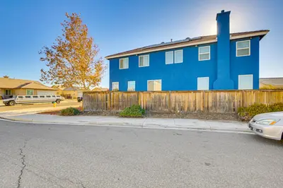 a blue house on the side of a street at Pool Table and Charcoal Grill Home in Victorville! in Victorville