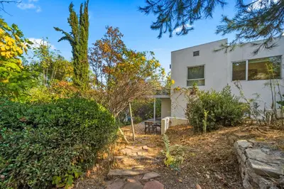 a white house with trees in front of it at Peaceful Tranquility w Nature in Los Angeles