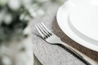 a fork sitting on top of a table with a plate at Oceanfront Studio with balcony in Redondo Beach