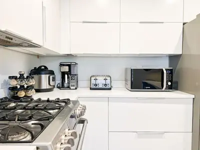 a white kitchen with a stove and a microwave at Relax and Play, 2BR Close to SoFi, LAX - SH1-LAD in Los Angeles