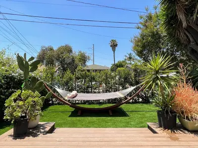 a person sleeping in a hammock in a garden at Relax and Play, 2BR Close to SoFi, LAX - SH1-LAD in Los Angeles