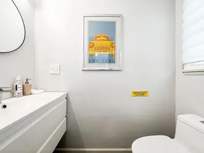 a bathroom with a picture of a yellow car on the wall at Relax and Play, 2BR Close to SoFi, LAX - SH1-LAD in Los Angeles