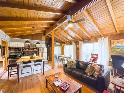 a living room with a couch and a table at Casita de Sergio - Peek-A-Boo Lake View, Walk to Lake, Fireplace in Big Bear Lake