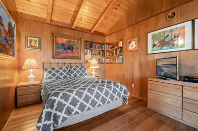 a bedroom with a bed and a tv in it at Casita de Sergio - Peek-A-Boo Lake View, Walk to Lake, Fireplace in Big Bear Lake