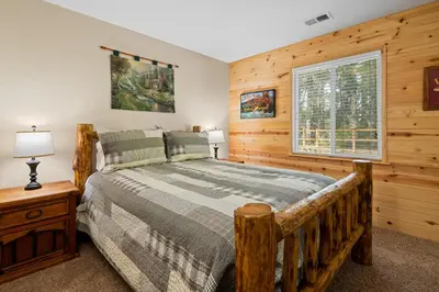 a bedroom with a bed and a window at Eagle Point Retreat - Sleeps 13 - 12 Adults Max, Game Room, Foosball, Fireplace, Deck, Barbecue in Big Bear Lake