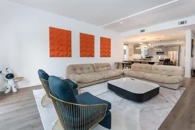 a living room with a couch and chairs and a table at Stunning 3-BR Residence with Free Parking & Patio in Los Angeles