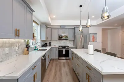 a kitchen with white cabinets and white counter tops at Stunning 3-BR Residence with Free Parking & Patio in Los Angeles