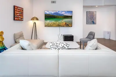 a white living room with a white couch at Luxury 2BR Stay Balcony Views and Free Parking in Los Angeles
