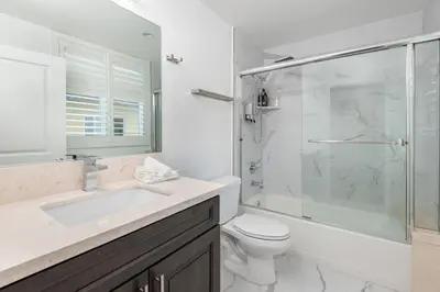 a bathroom with a shower and a toilet and a sink at Luxury 2BR Stay Balcony Views and Free Parking in Los Angeles