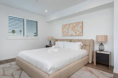 a white bedroom with a large bed and a window at Modern and Chic 2BR Gem with Luxe Finishes, Parking in Los Angeles
