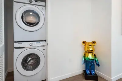 a toy dog next to a washing machine at Modern and Chic 2BR Gem with Luxe Finishes, Parking in Los Angeles