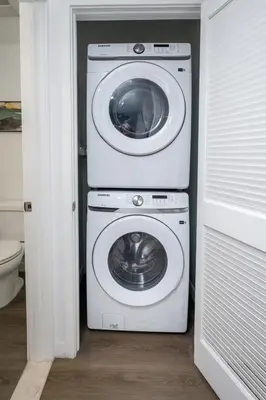a washing machine and a washer in a bathroom at Experience Lavish LA Living Sleek 2BR with Parking in Los Angeles