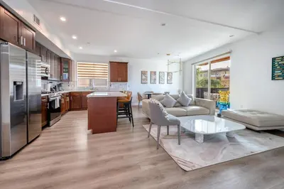 a kitchen and living room with a couch and a table at Experience Lavish LA Living Sleek 2BR with Parking in Los Angeles