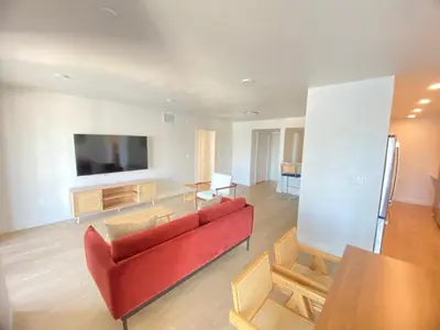 a living room with a red couch and chairs at Modern Marina Escape with Harbor Views in Los Angeles