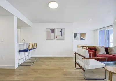 a living room with a red couch and a table at Modern Marina Escape with Harbor Views in Los Angeles