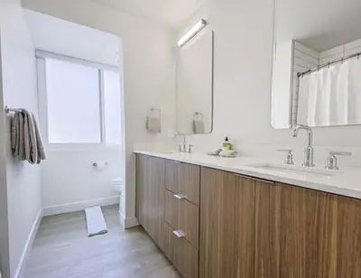 a bathroom with a sink and a tub and a mirror at Modern Marina Escape with Harbor Views in Los Angeles