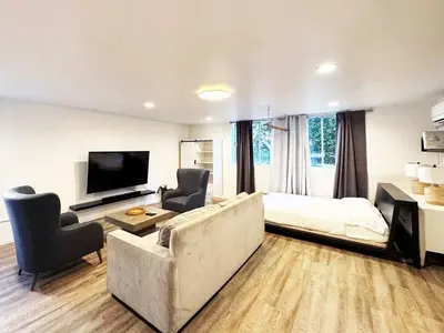 a living room with a couch and a bed at Cozy LA Studio Steps from SoFi and LAX - SH3 - LAD in Los Angeles