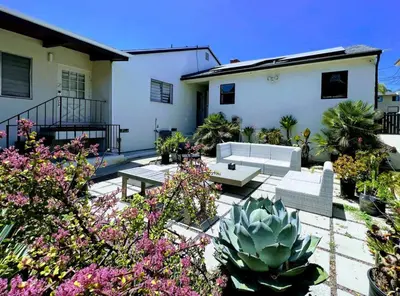 a patio with couches and plants in front of a house at Cozy LA Studio Steps from SoFi and LAX - SH3 - LAD in Los Angeles