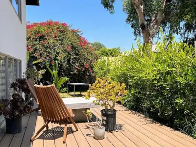 a rocking chair sitting on a deck with plants at Cozy LA Studio Steps from SoFi and LAX - SH3 - LAD in Los Angeles