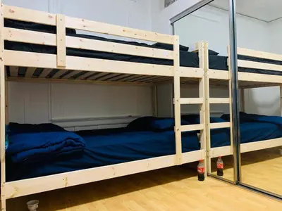 two bunk beds in a room with a blue bed at Homes for Soul Los Angeles in Los Angeles
