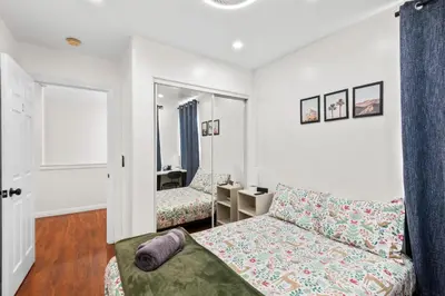 a living room with a couch and a mirror at Game Room & In-Unit Laundry - 15 Min to Disney! in Artesia