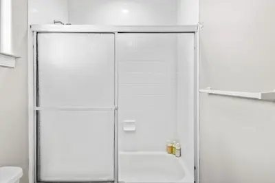 a shower with a glass door in a bathroom at Game Room & In-Unit Laundry - 15 Min to Disney! in Artesia