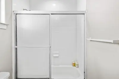 a shower with a glass door in a bathroom at Game Room & In-Unit Laundry - 15 Min to Disney! in Artesia
