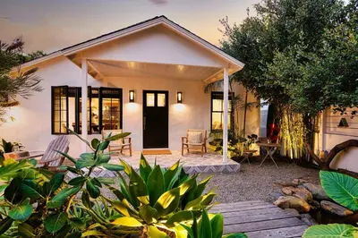 a small white house with a patio in front of it at Channel Islands Beach Retreat in Oxnard
