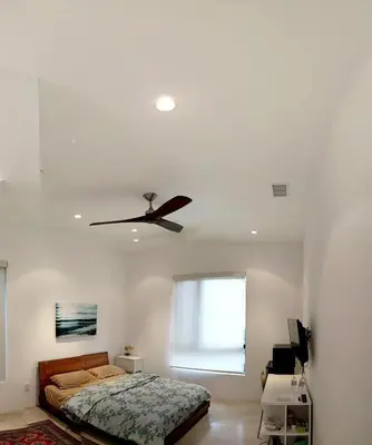 a bedroom with a bed and a ceiling fan at Luxury suite with private entrance in Los Angeles