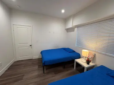 a bedroom with a blue bed and a window at Blue Stay Walk to BMO Stadium and USC in Los Angeles