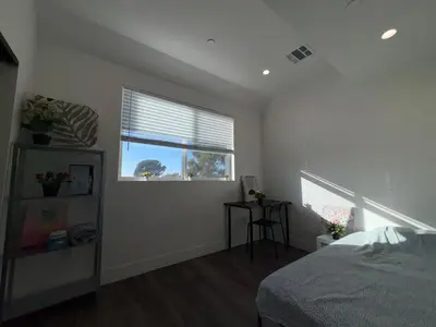 a bedroom with a bed and a window at Blue Stay Walk to BMO Stadium and USC in Los Angeles