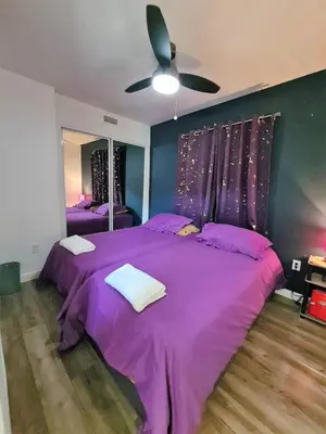 a purple bed in a bedroom with a ceiling fan at 3 bedroom with Hot Tub and Video game console 10 minutes from Rodeo Drive Beverly Hills in Los Angeles