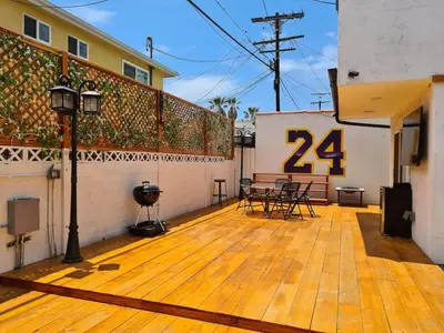 a large deck with a table and chairs on it at 3 bedroom with Hot Tub and Video game console 10 minutes from Rodeo Drive Beverly Hills in Los Angeles