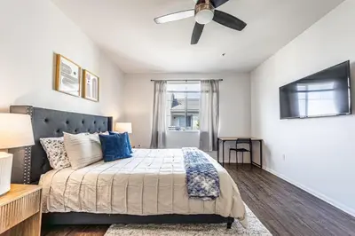 a bedroom with a bed and a ceiling fan at Modern Townhouse with 4 Bedrooms Near LAX in Los Angeles