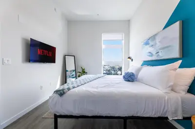 a bedroom with a large bed and a window at Modern Living, Stunning city views, 1Mile to Dodger Stadium in Los Angeles