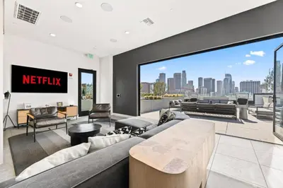 a living room with a couch and a view of the city at The Downtown Haven Suite, 1Mile to Dodger Stadium in Los Angeles