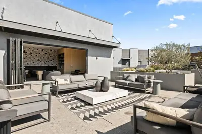 a living room with couches and chairs on a patio at The Downtown Haven Suite, 1Mile to Dodger Stadium in Los Angeles