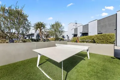 a white table on the grass in a yard at The Sky loft Suite, DTLA Sunset Views in Los Angeles
