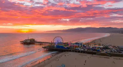 a view of a beach with a pier and a roller coaster at Cozy apartment in Santa Monica parking, Gym, Pool in Los Angeles