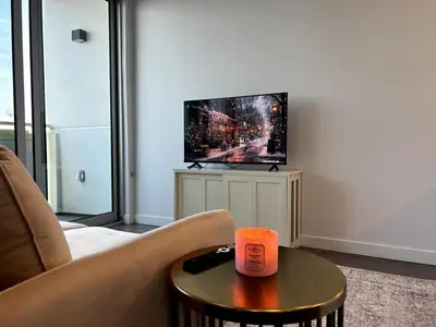 a living room with a couch and a tv at Cozy apartment in Santa Monica parking, Gym, Pool in Los Angeles