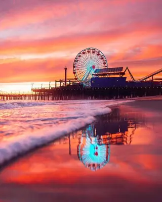 a ferris wheel on the beach at sunset at Cozy apartment in Santa Monica parking, Gym, Pool in Los Angeles