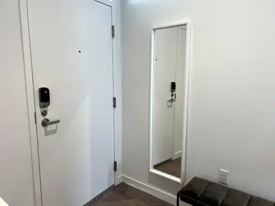 a mirror in a white room with a couch at Cozy apartment in Santa Monica parking, Gym, Pool in Los Angeles