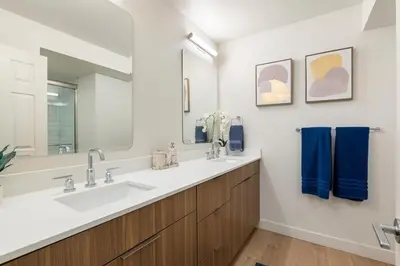 a bathroom with two sinks and a large mirror at Jade Breeze - Elegant 2BR near Water Outstanding Amenities in Los Angeles