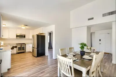 a kitchen and dining room with a table and chairs at Modern 4-BR near China Lake in Ridgecrest