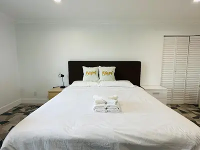 a large white bed with a pair of glasses on it at Luxe Stay Room with Private Bathroom 55 in Los Angeles